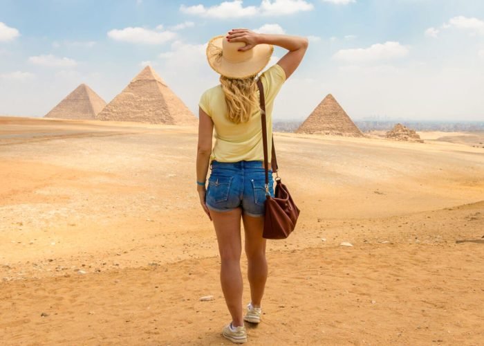 A-great-shot-of-a-solo-female-traveler-in-front-of-the-pyramids
